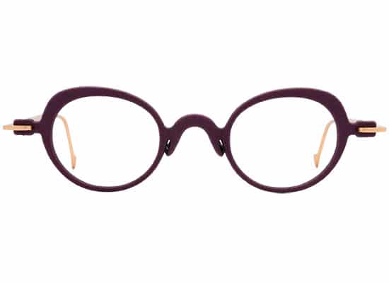 Round eyeglasses with thin matte brown frames and gold details on the hinges. acuitis brand