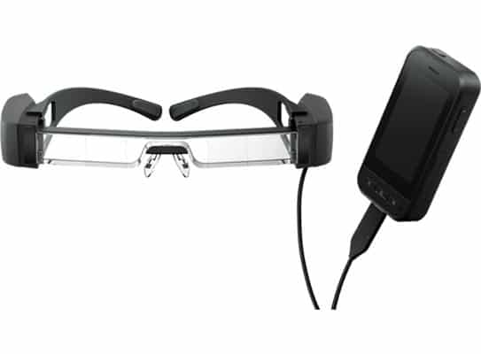 A pair of Moverio BT-40s augmented reality glasses with a black and transparent headband connected by a cable to a black smartphone.