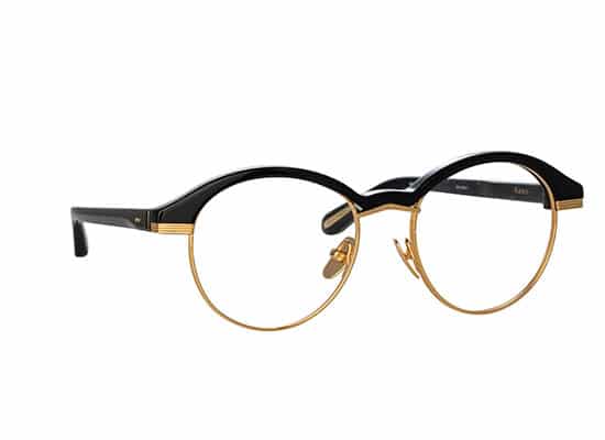 Classic round glasses with black and gold frames, creating a refined and timeless aesthetic. Linda Farrow brand