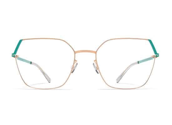 Modern hexagonal glasses with a slim rose gold frame and contrasting green temple tips for a contemporary look. mykita brand