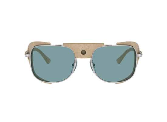 Fashion-forward sunglasses with a translucent gray split frame design and leather-covered gold central bridge, Persol branded transition lenses