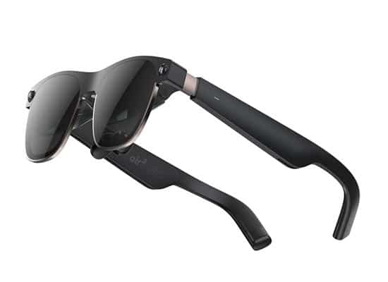 Black smart glasses with tinted lenses and slim arms, showing a button and connection ports on the side of the frame.