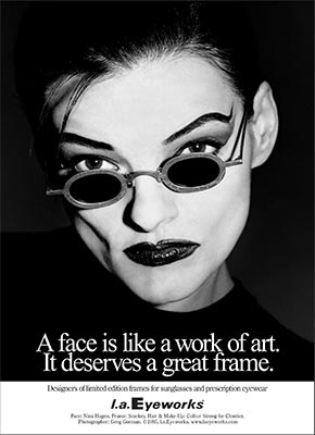 Black and white portrait of a person with dramatic makeup, wearing unique prescription glasses with the same quote and brand as the first image.