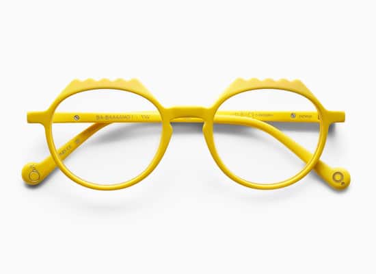 Yellow eyeglasses with a modern wavy design with technical details on the temple.