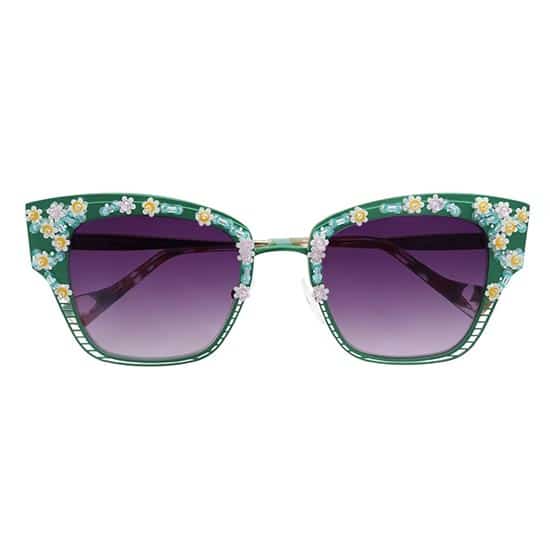 Extravagant sunglasses with green frame decorated with white flowers and pearls, purple gradient lenses.