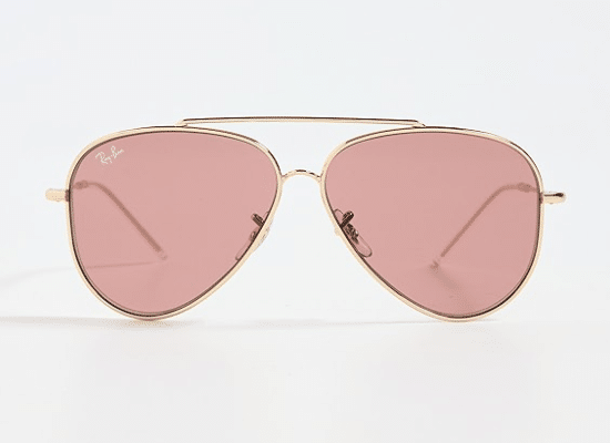 Ray-Ban aviator sunglasses with gold frames and pink lenses.